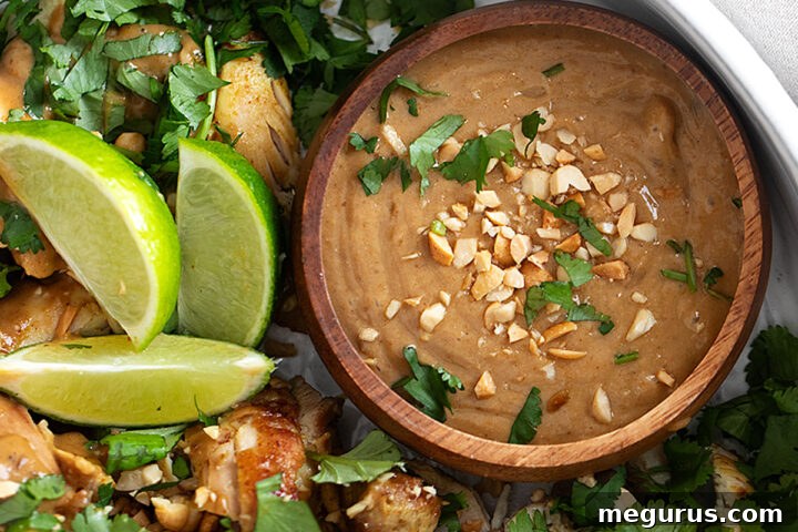 Coconut chicken with peanut sauce in a serving bowl, ready to be enjoyed.