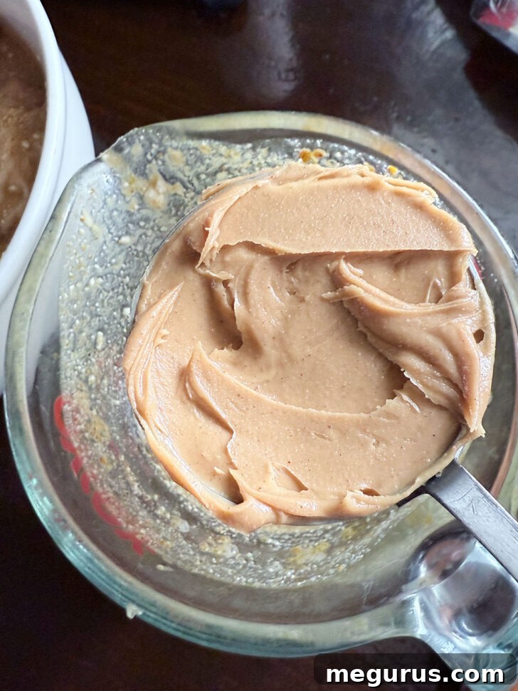 Adding creamy peanut butter to the flavorful reserved marinade for the satay-style sauce.