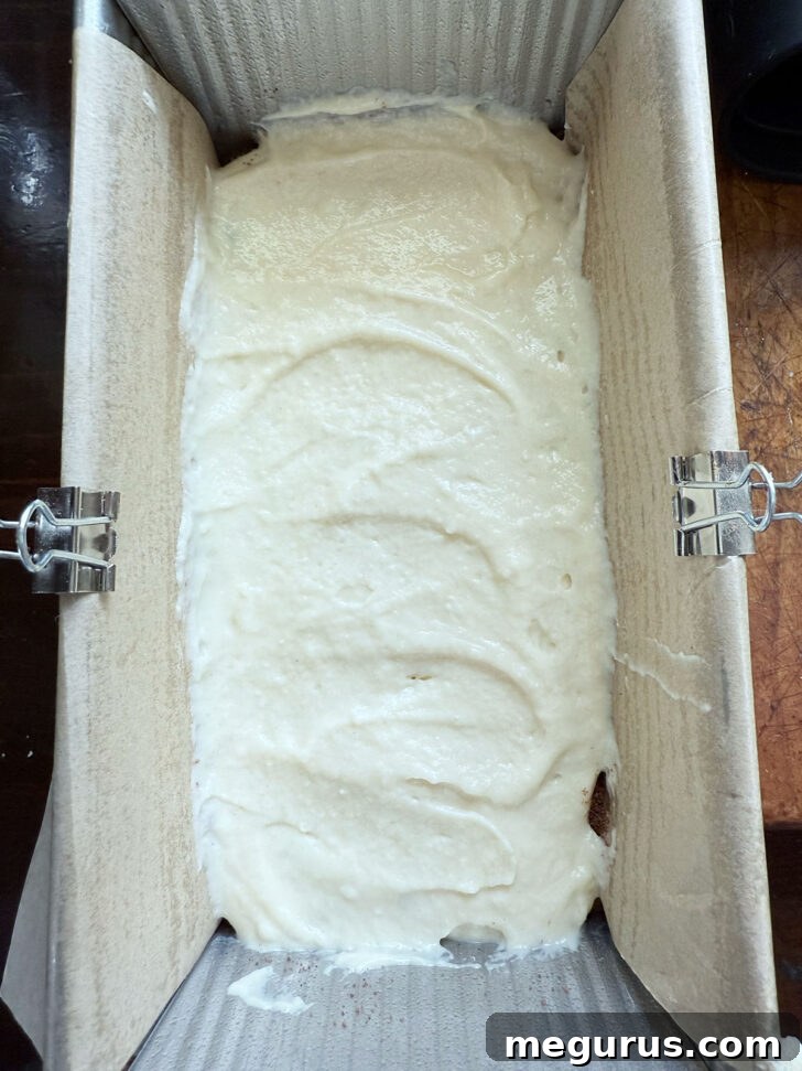 Smooth batter spread evenly over the filling layer.