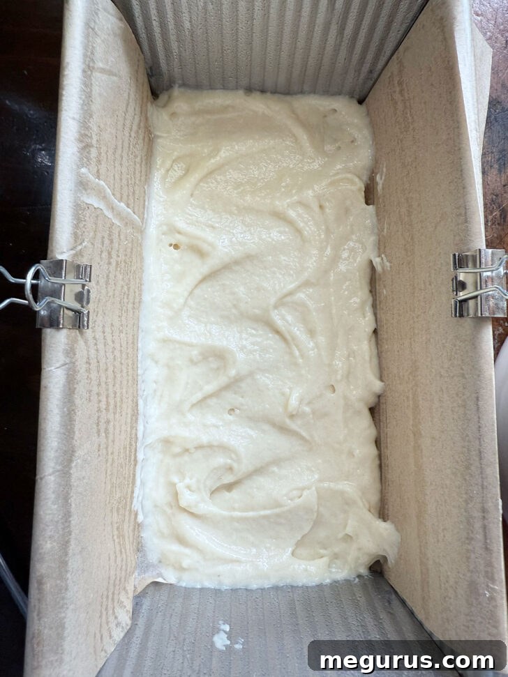 First layer of cake batter evenly spread in the loaf pan.