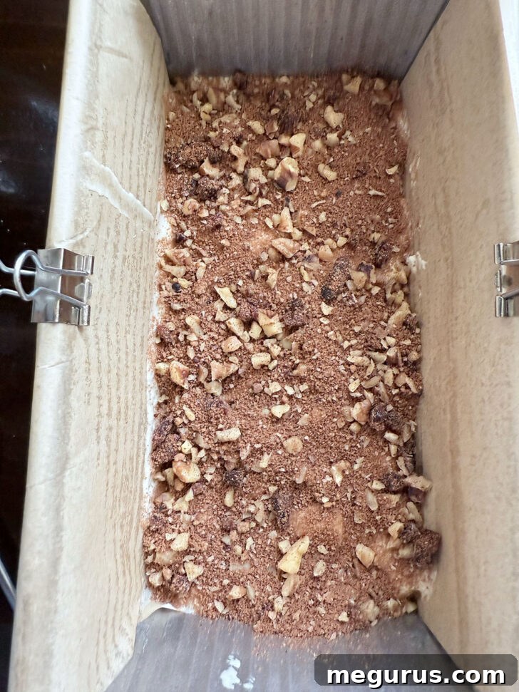 A generous layer of nut and spice filling sprinkled over the batter.