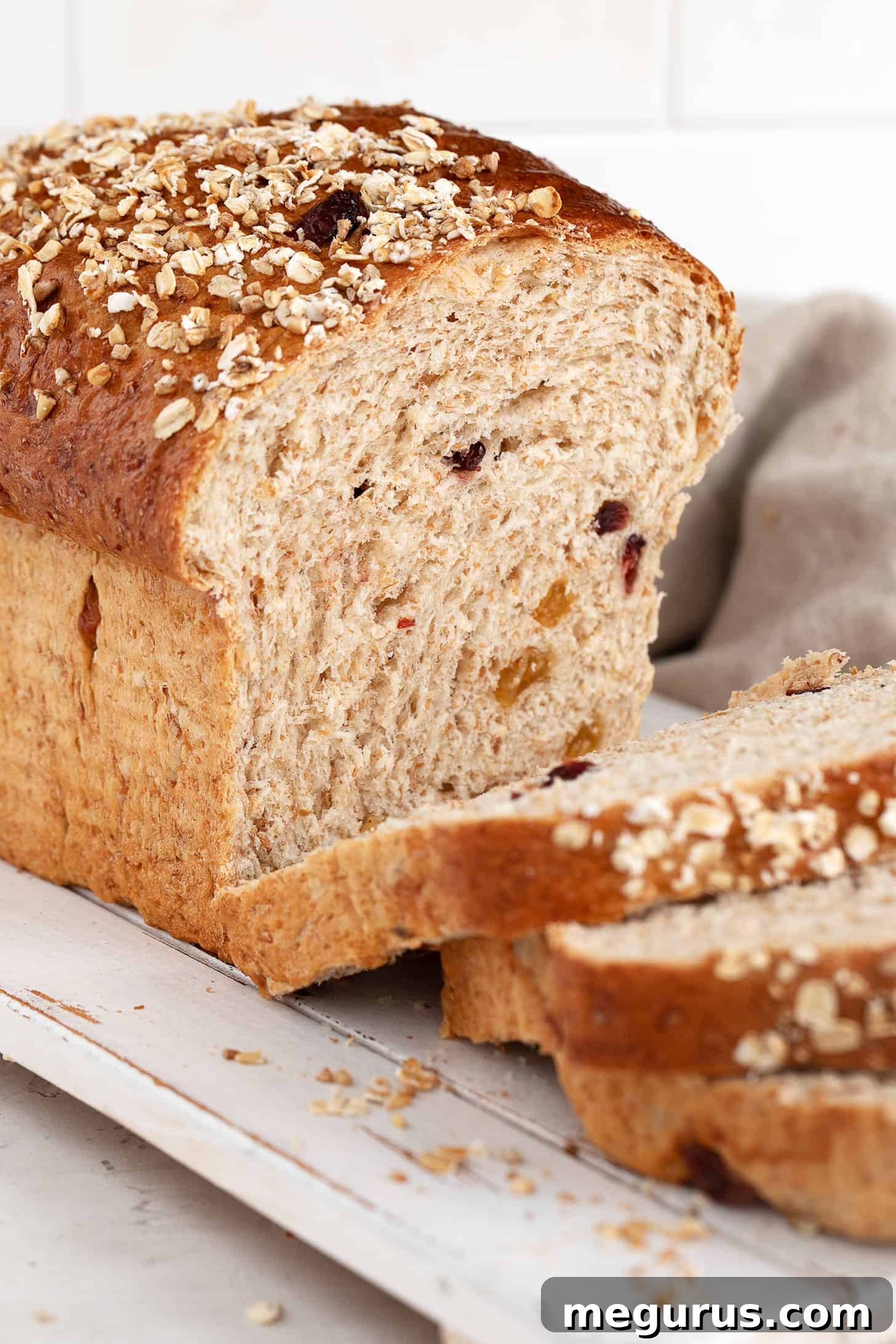 Delicious harvest grain bread, perfectly sliced and arranged on a wooden cutting board.