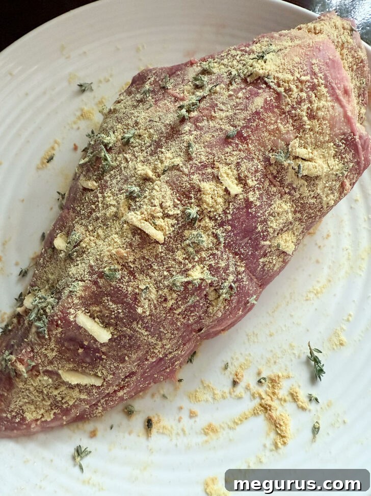 Mustard mixture rubbed over the roast.