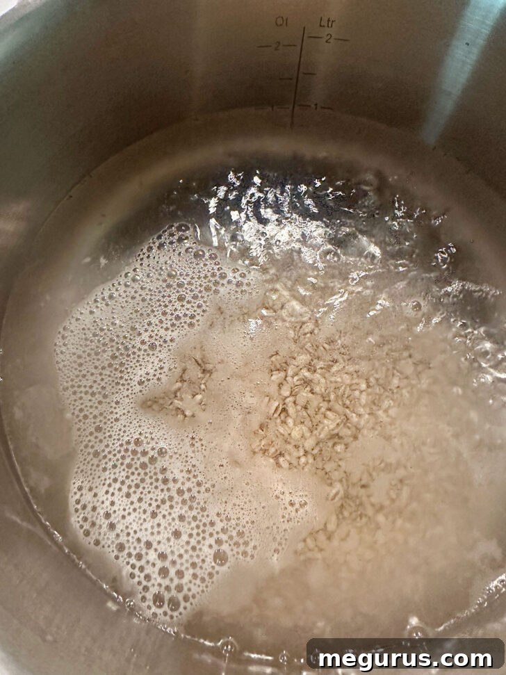 Pearl barley simmering gently in a saucepan.