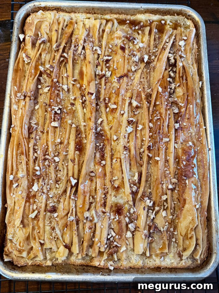 The finished maple crinkle cake, sliced and ready to serve, within its baking pan.