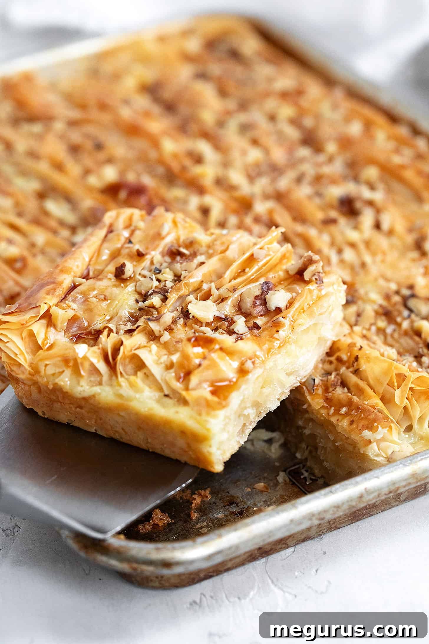 A close-up shot of a maple crinkle cake, sliced and showing its crispy layers and custardy interior.