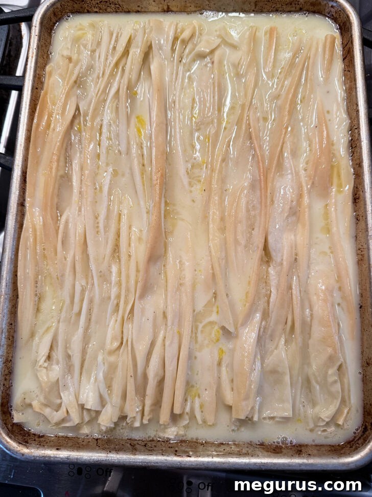 The phyllo pastry after the custard has been poured, showing it nestled into the crinkles.