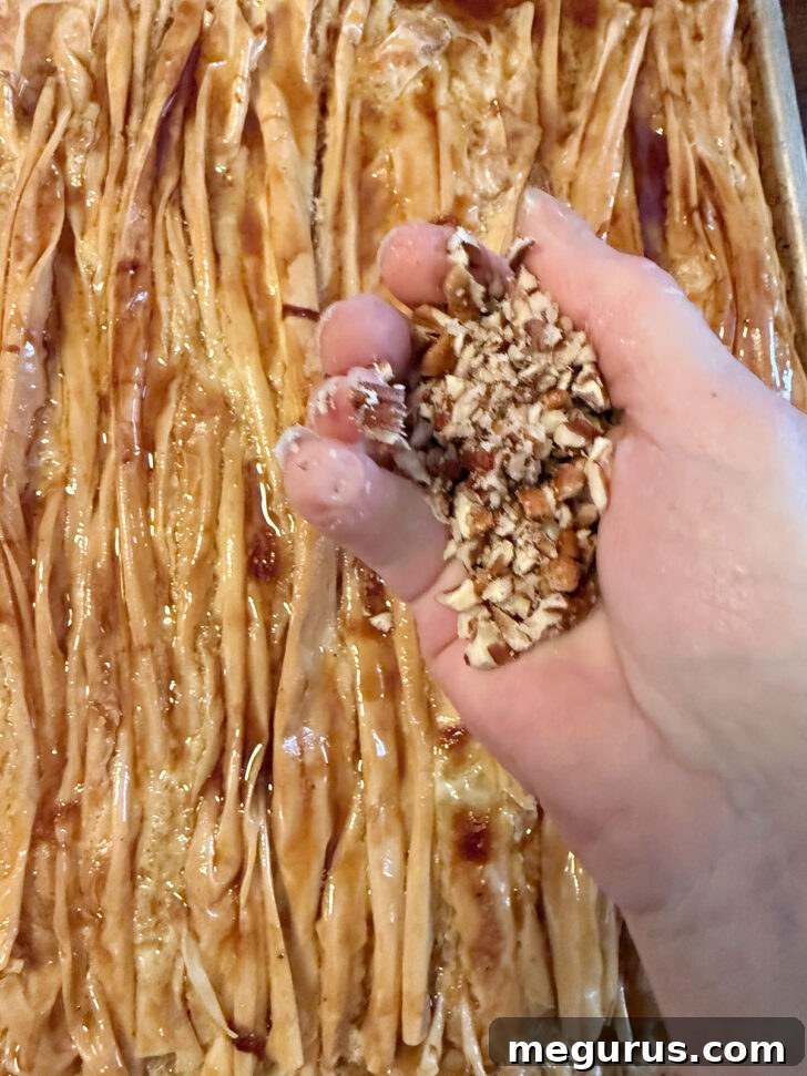 Finely chopped pecans ready to be scattered over the warm maple crinkle cake.