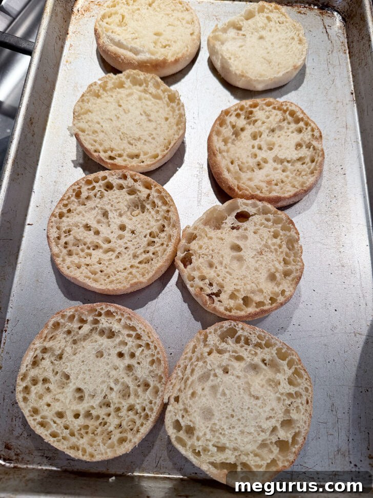 Split English muffins on baking sheet.