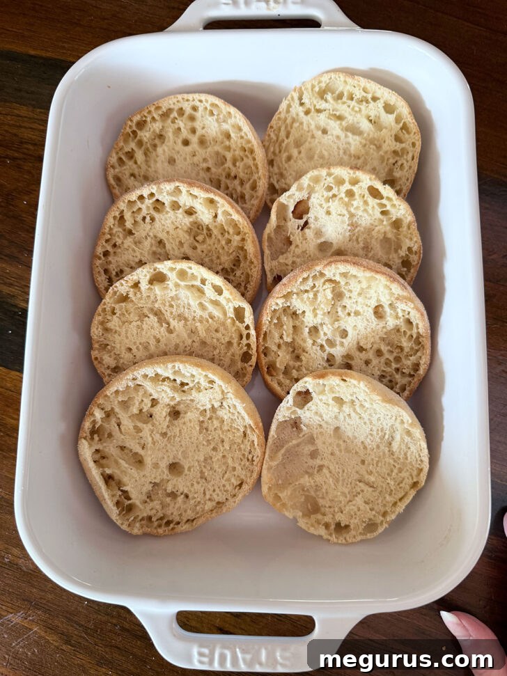 Toasted English muffins in baking dish.