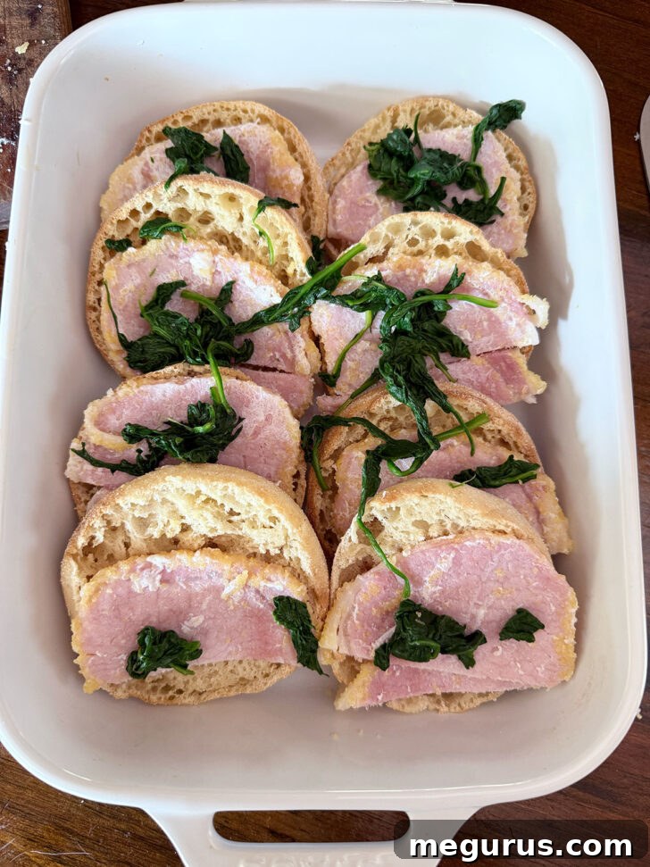 English muffins topped with back bacon and spinach.