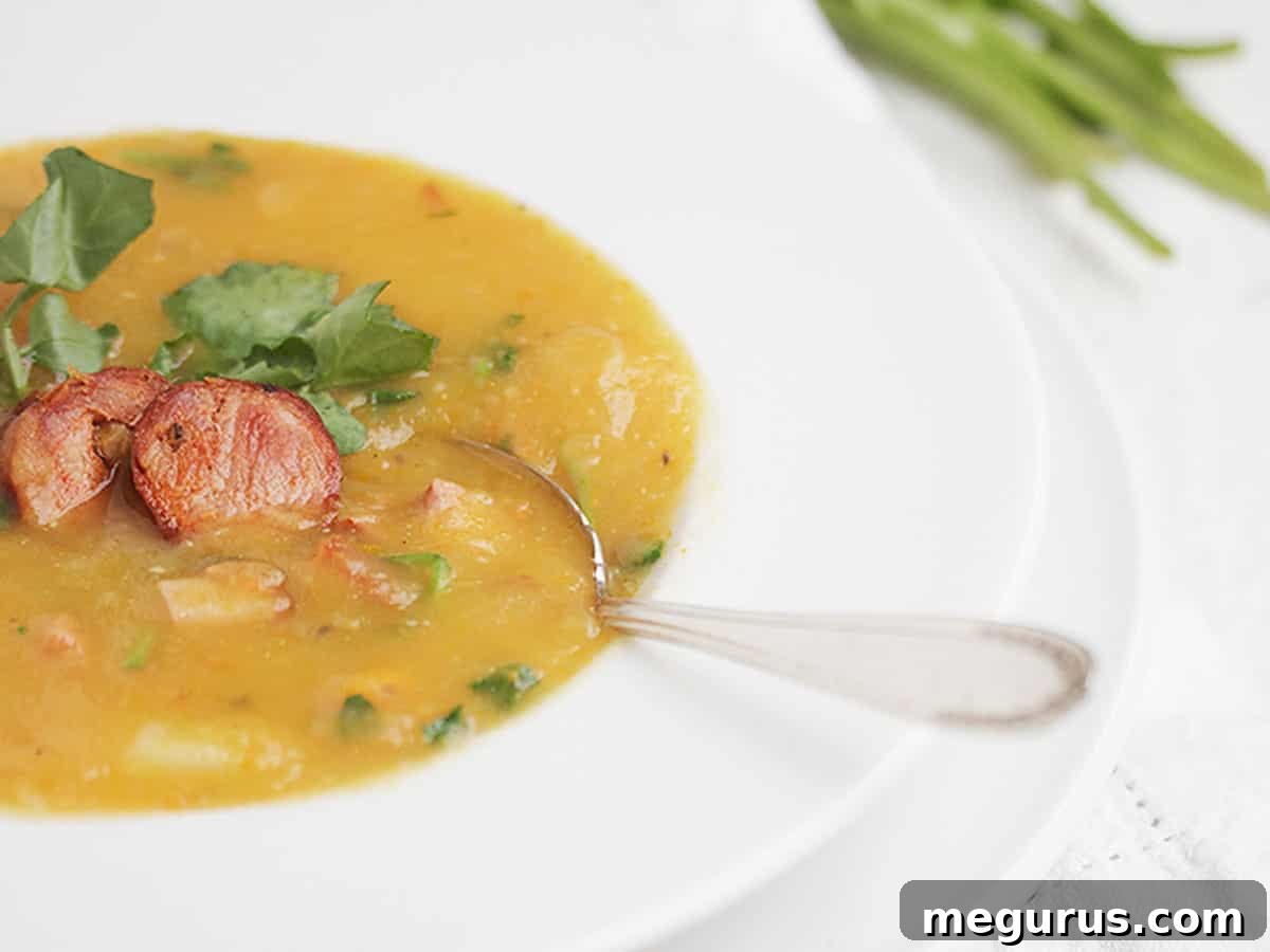 Hearty Caldo Verde soup with chunks of chorizo and fresh watercress