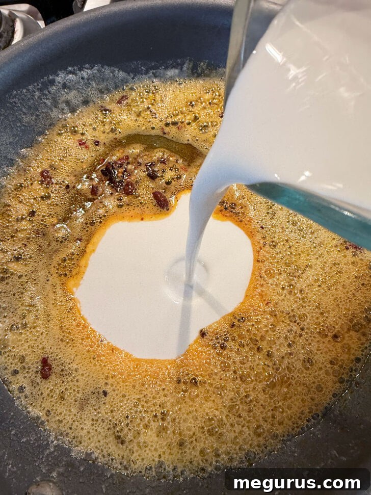 Adding cream to skillet.