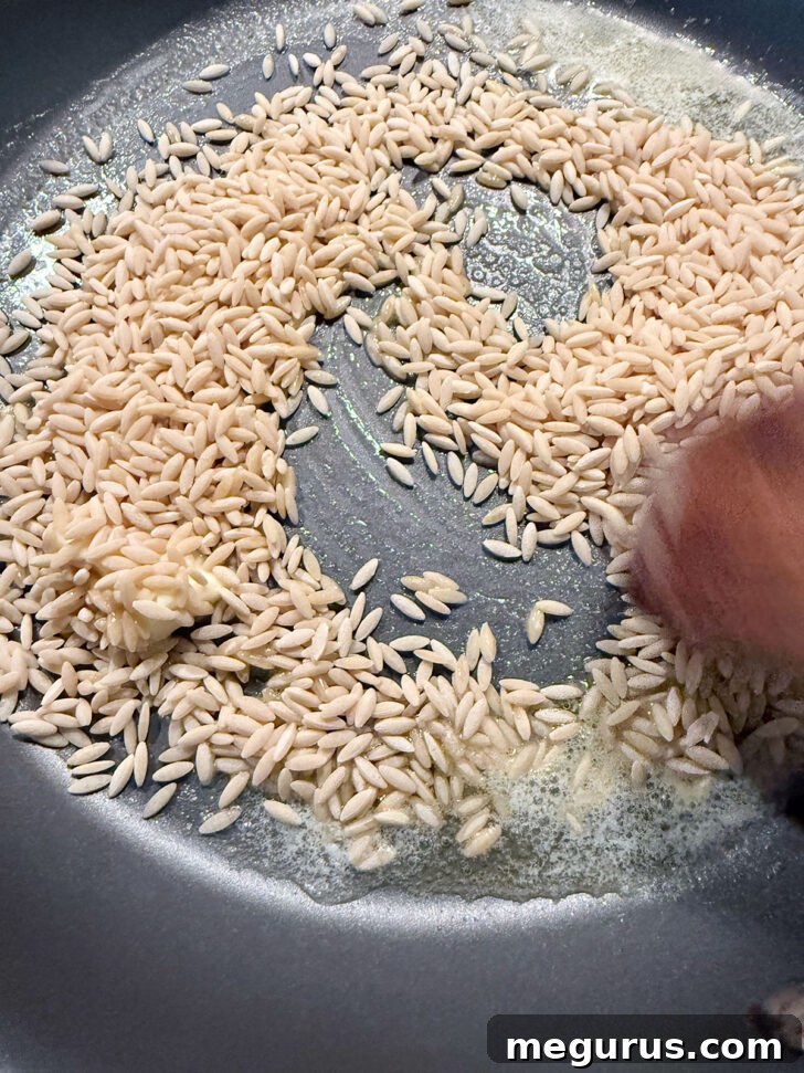 Toasting the orzo briefly in melted butter in a skillet.