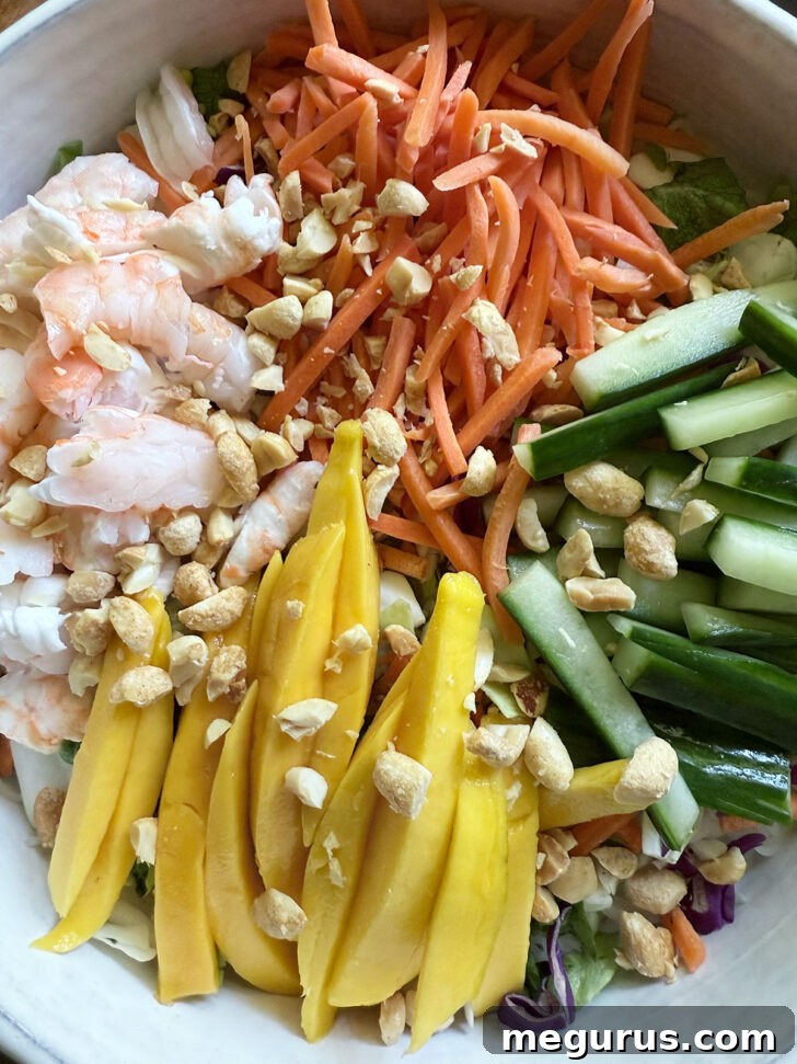 Sprinkling chopped peanuts over the assembled salad for added crunch and flavor.