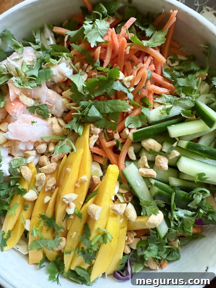 Adding fresh chopped cilantro as a final garnish to the colorful summer roll salad.