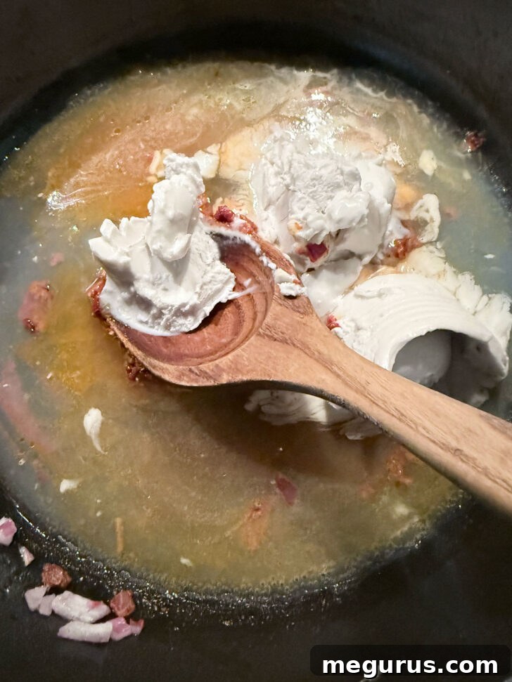 Adding the coconut milk to the skillet.