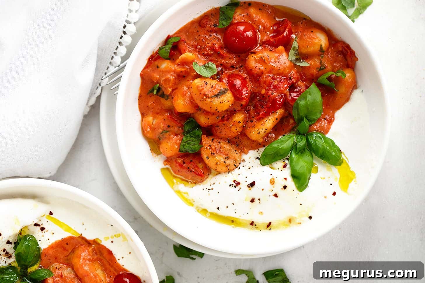 Creamy Gnocchi Burrata served in a rustic bowl, garnished with fresh basil and a drizzle of olive oil.