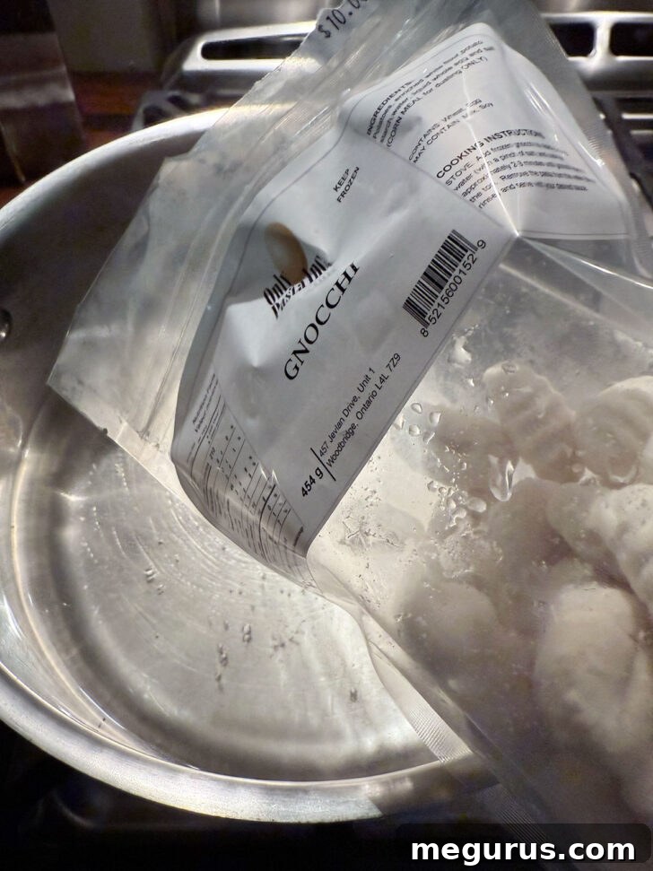 Pouring the frozen gnocchi into boiling water.