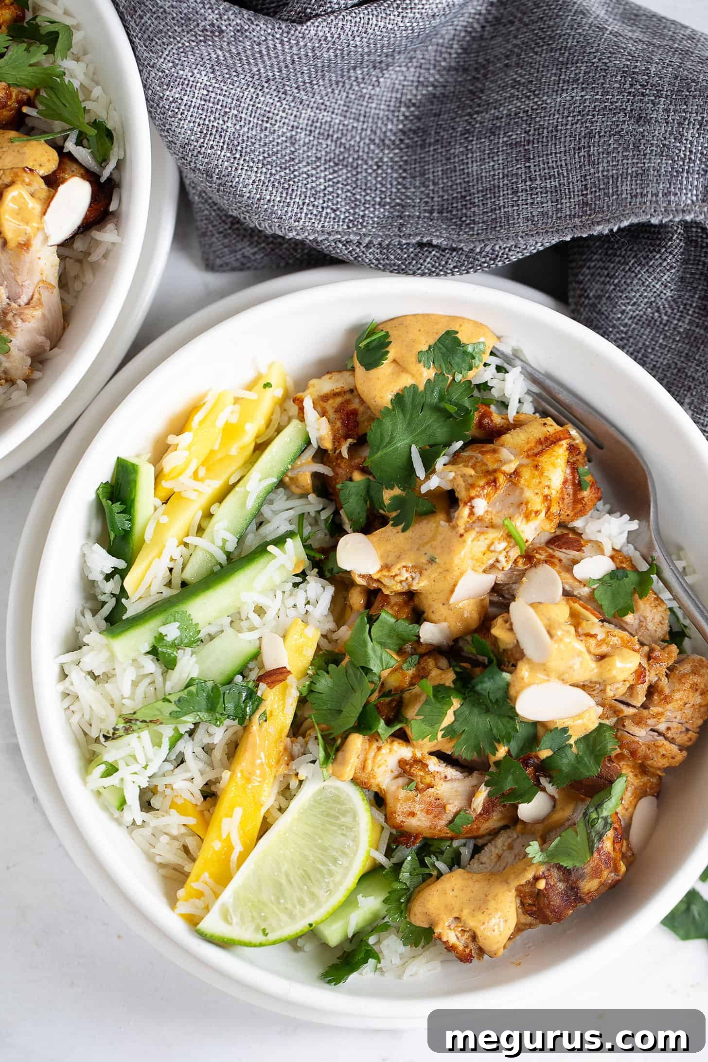 A beautifully presented Coronation Chicken Rice Bowl in a ceramic bowl.