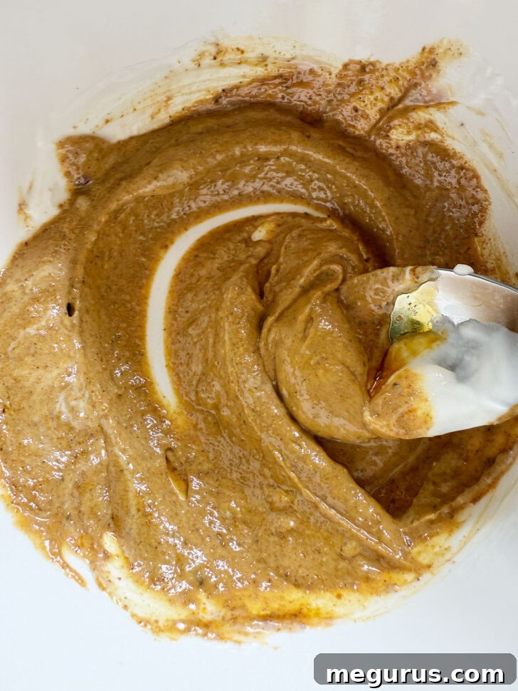 Mixing the chicken marinade ingredients in a bowl.