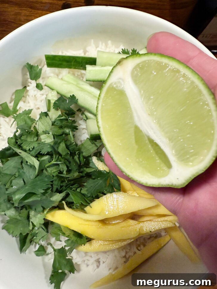 Drizzling lime juice over the rice salad ingredients.