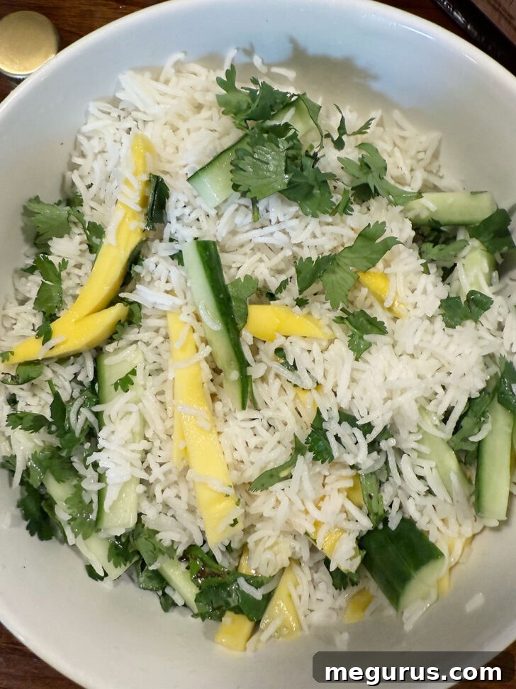 Rice salad tossed together in a bowl, showing vibrant colors.