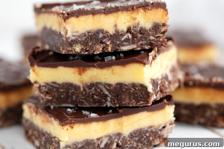 Delicious Nanaimo bars cut and stacked, ready to be served, showing their appealing layers.