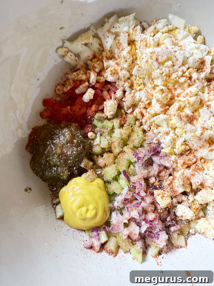 Yellow mustard added to the bowl, alongside relish and vegetables.