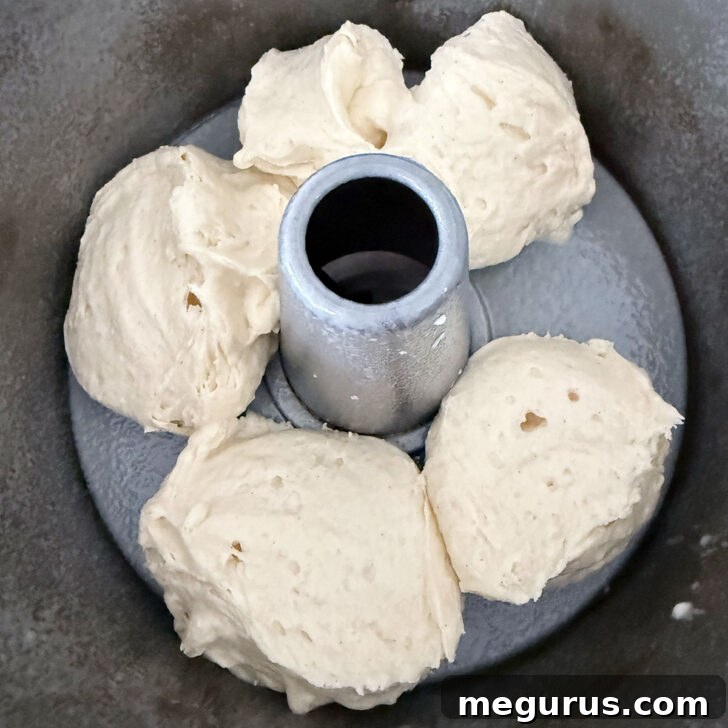 Spooning part of the batter into the tube pan.