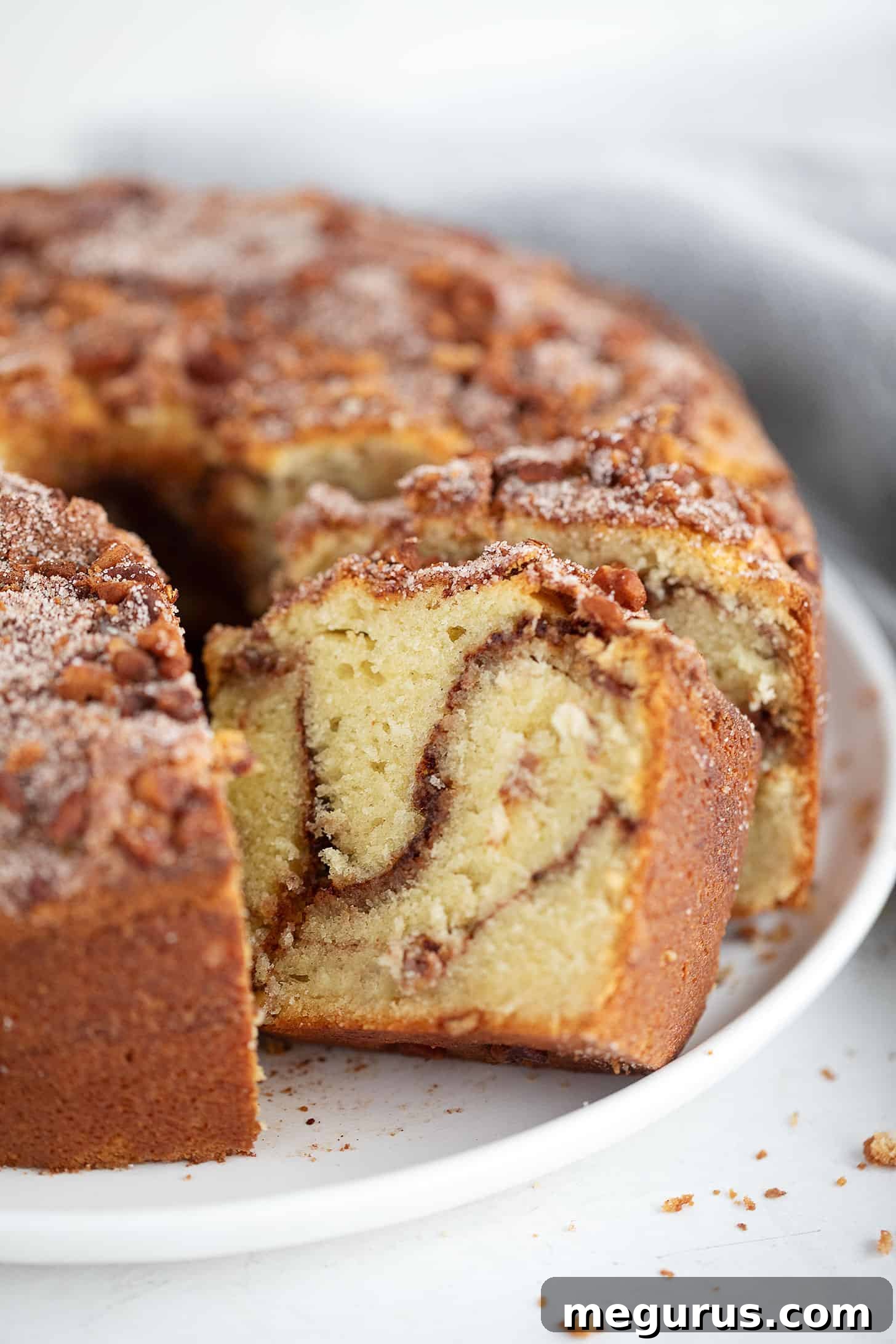 Tube pan sour cream coffee cake on a serving plate.