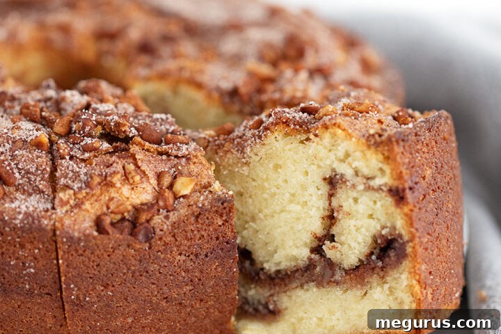 Classic Tube-Pan Sour Cream Coffee Cake sliced on a serving platter.