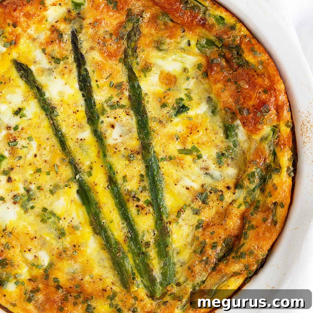 Crustless asparagus quiche in pie dish.