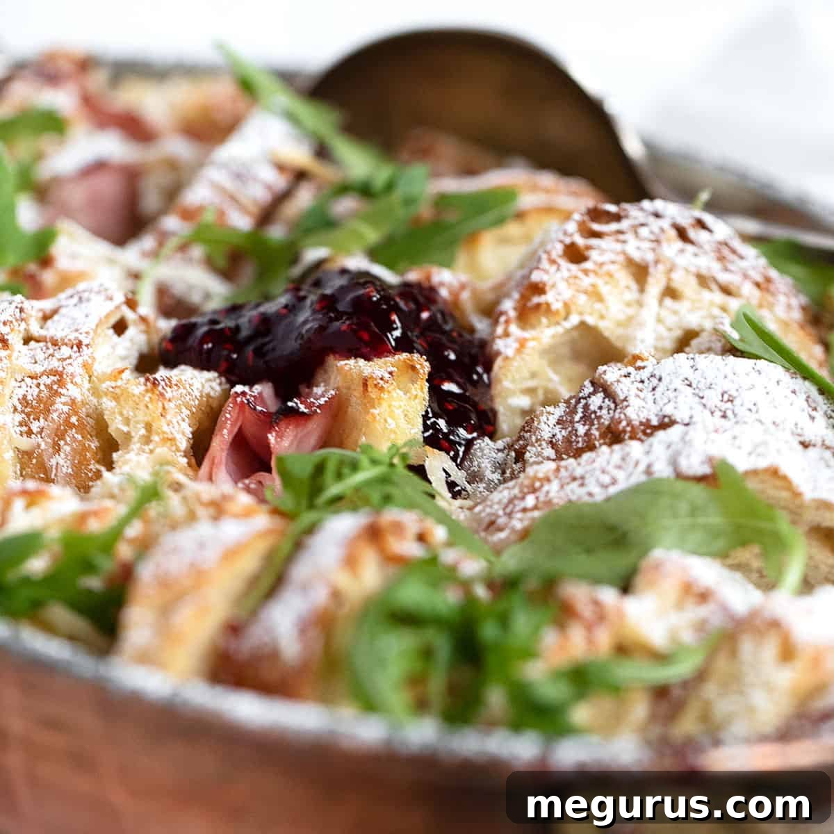 Savoury Ham and Cheese Bread Pudding in baking dish, golden and bubbly.