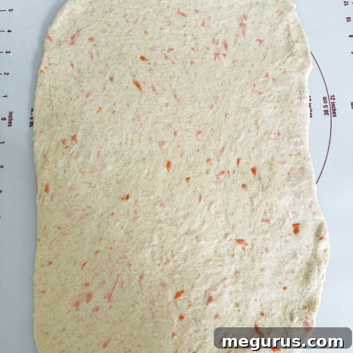 Dough meticulously rolled out into a rectangular shape.