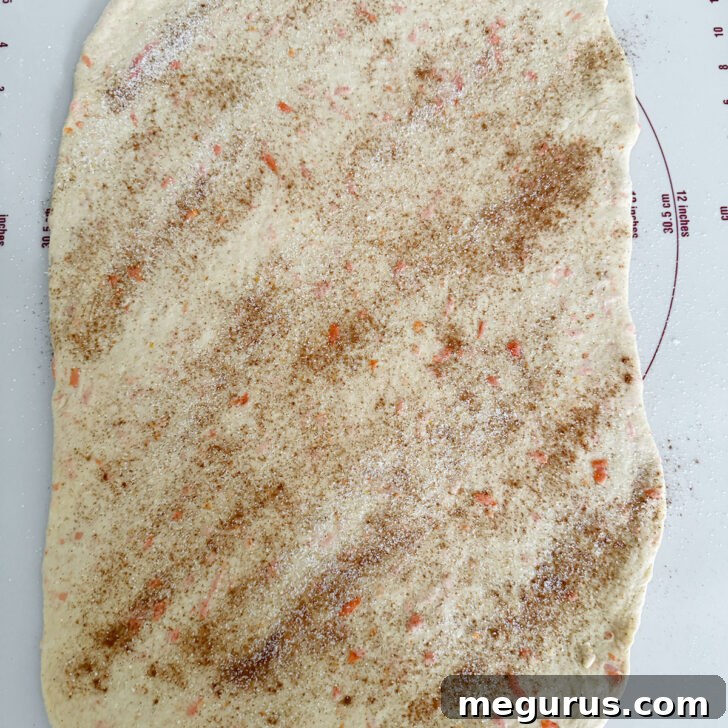 Dough generously sprinkled with a mixture of cinnamon and sugar.