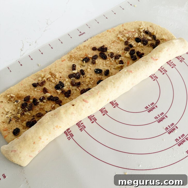 Rolling the dough up jelly roll style from the long side.