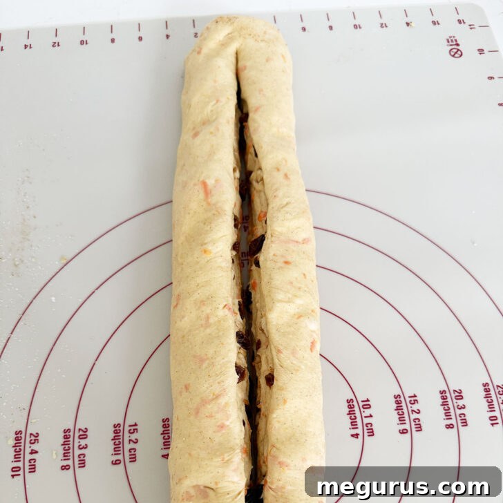 Dough roll sliced down the center, leaving one end attached.