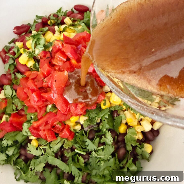 Adding the dressing to the salad.