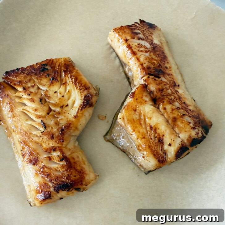 Seared cod on parchment paper.