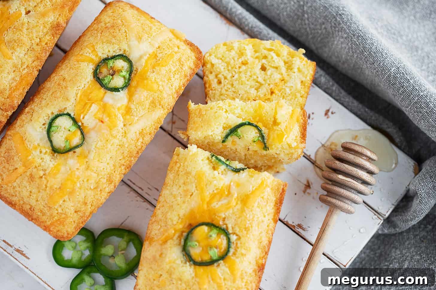 Mini cornbread loaves on a serving board.
