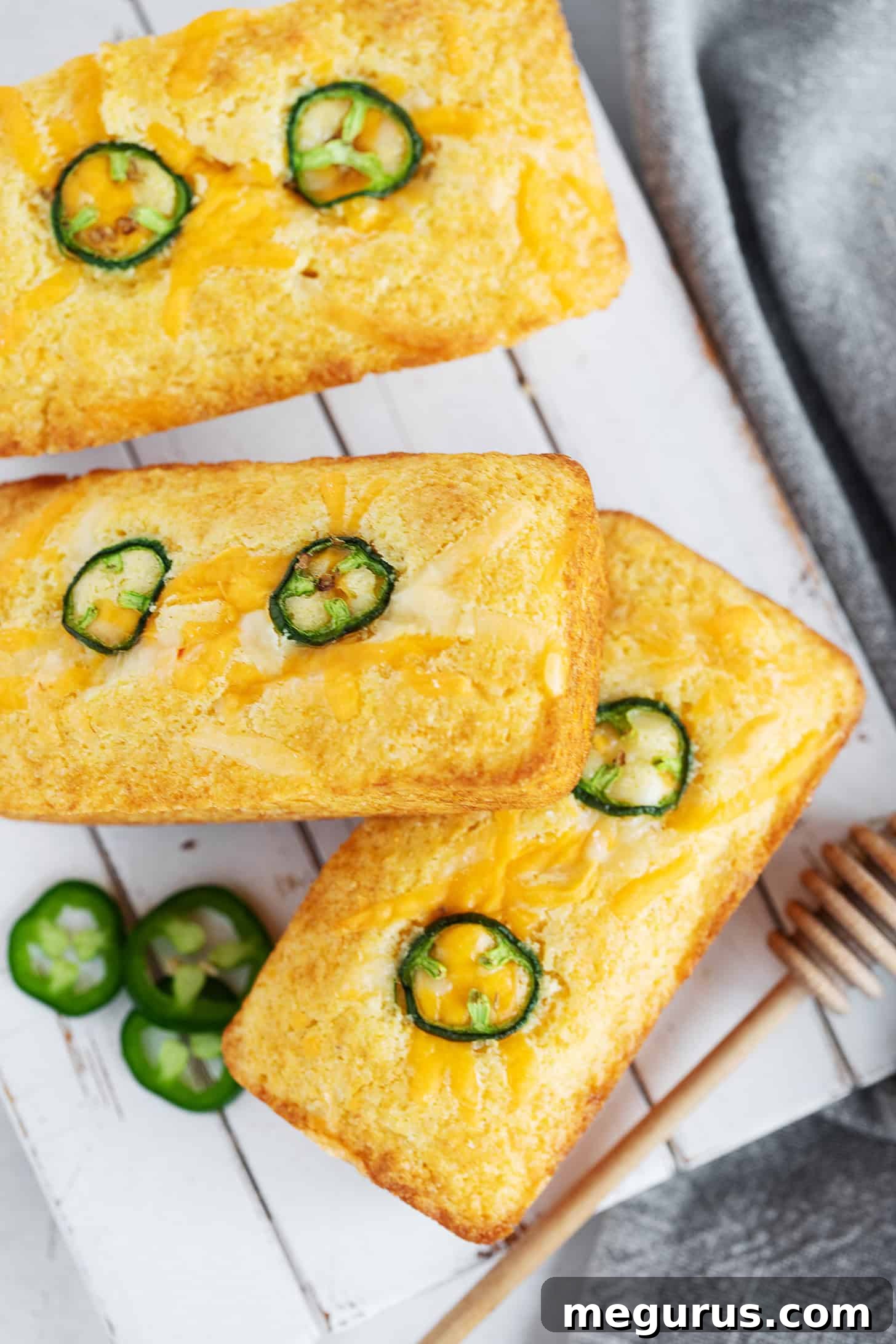 Mini cornbread loaves on a serving board.