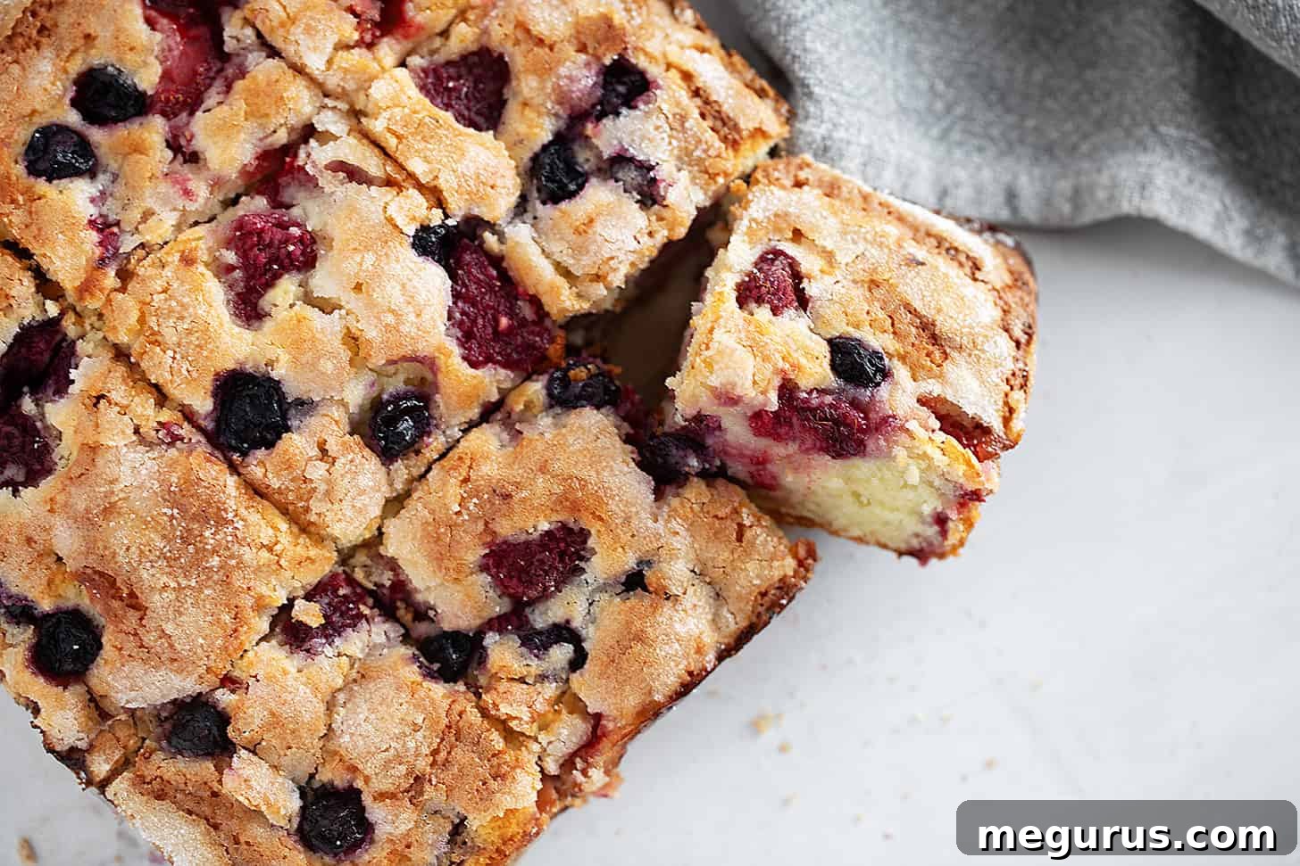 Mixed berry yogurt cake sliced.