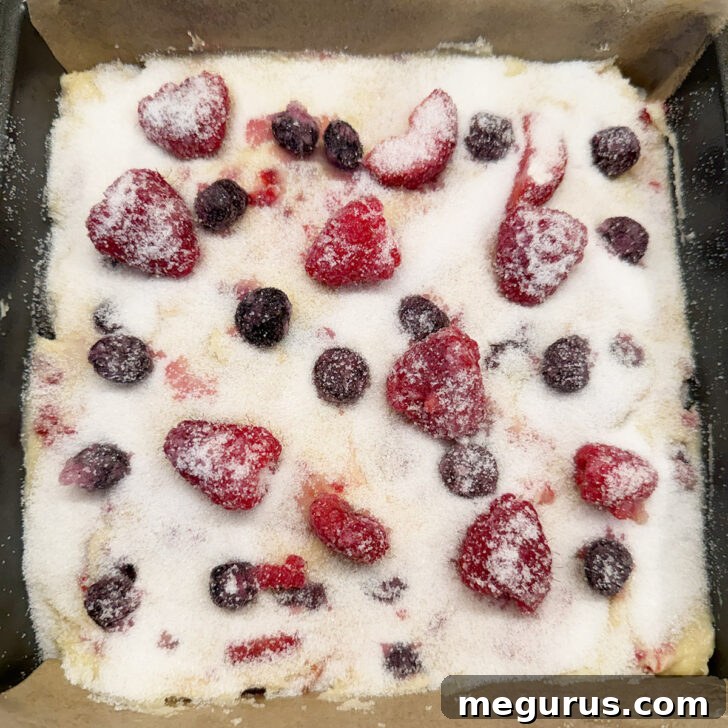 White sugar sprinkled on the berry yogurt cake before baking.