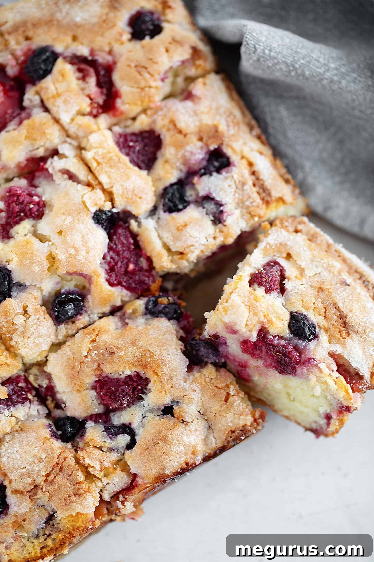 Mixed berry yogurt cake sliced.