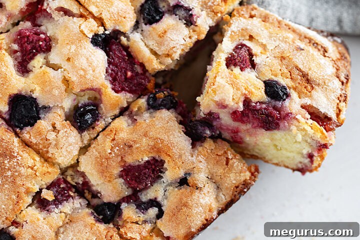 Mixed berry yogurt cake sliced.