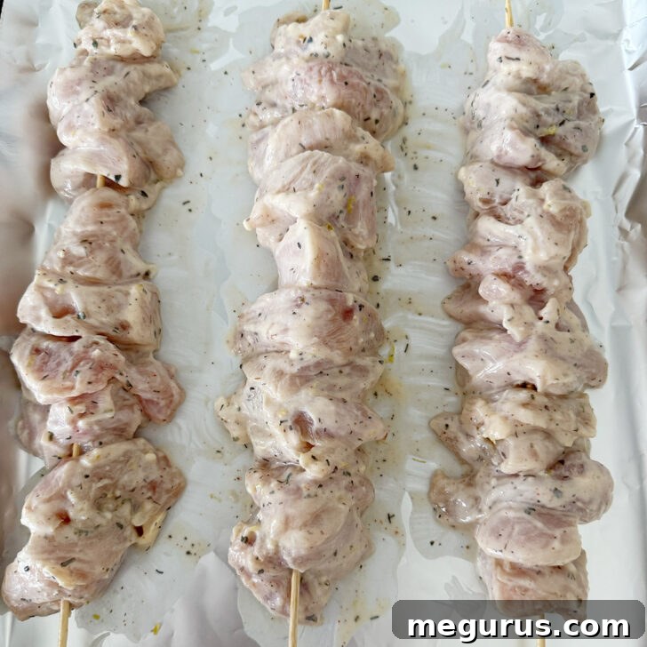 Grilled Chicken Souvlaki Salad with Tzatziki and Lemon Dressing 5 Souvlaki-marinated chicken breast pieces threaded onto skewers.